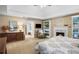 Large primary bedroom with a fireplace, sitting area, tray ceiling, and ensuite bathroom at 6380 Bannerhorn Run, Alpharetta, GA 30005