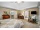 Primary bedroom features a tray ceiling, sitting area, fireplace and ensuite bathroom at 6380 Bannerhorn Run, Alpharetta, GA 30005