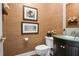 Beautiful powder room with wall art, dark vanity and a round sink at 6380 Bannerhorn Run, Alpharetta, GA 30005