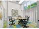 A modern conference room featuring a round table, four chairs, and natural lighting at 840 United Se Ave # 205, Atlanta, GA 30312