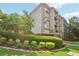 Exterior of the condo building featuring brick accents, trimmed hedges, and well-maintained landscaping at 840 United Se Ave # 205, Atlanta, GA 30312
