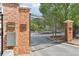 Exterior shot of a brick and iron automatic security gate with signage at 840 United Se Ave # 205, Atlanta, GA 30312