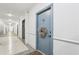 The welcoming entryway of this condo has neutral paint, crown moulding, and a door wreath at 840 United Se Ave # 205, Atlanta, GA 30312