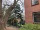 Brick building with large windows, mature trees and landscaping, stair and wrought iron rail at 1148 Briarcliff Ne Rd # 1, Atlanta, GA 30306