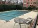 View of community pool with a cover, lounge chairs, and table with chairs at 1148 Briarcliff Ne Rd # 1, Atlanta, GA 30306