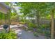 Landscaped backyard with mature trees, stone patio, built-in fire pit and outdoor cooking area at 183 Cleveland # B, Atlanta, GA 30316
