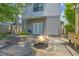 Backyard with modern gray home, landscaped yard, stone patio, and a built-in fire pit at 183 Cleveland # B, Atlanta, GA 30316
