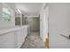 Bathroom featuring marble floors, double sink vanity and walk-in shower with gray tile and glass door at 183 Cleveland # B, Atlanta, GA 30316