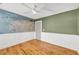 Lovely bedroom featuring wainscoting and a world map mural with wood floors at 183 Cleveland # B, Atlanta, GA 30316