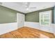 Stylish bedroom features a wainscoting, a large window, and beautiful wood floors at 183 Cleveland # B, Atlanta, GA 30316