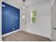 Bright entryway featuring a blue accent wall, white door and neutral vinyl floors at 183 Cleveland # B, Atlanta, GA 30316