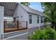Side view of the house with a metal roof, gray and white siding, and a small outdoor patio at 183 Cleveland # B, Atlanta, GA 30316