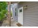 Side view of a home featuring a white door, gray siding, and exterior lighting fixture at 183 Cleveland # B, Atlanta, GA 30316