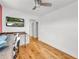 Bonus room featuring hardwood floors, ceiling fan, TV, desk with bar stools, and views to other rooms at 183 Cleveland # B, Atlanta, GA 30316
