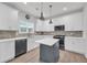 Modern kitchen features white cabinets, gray backsplash, stainless steel appliances and gray island at 183 Cleveland # B, Atlanta, GA 30316
