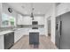 Modern kitchen features white cabinets, gray backsplash, stainless steel appliances and gray island at 183 Cleveland # B, Atlanta, GA 30316
