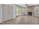 Open-concept living room with fireplace, modern ceiling fan, and doors to the exterior at 183 Cleveland # B, Atlanta, GA 30316