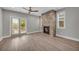 Bright living room features a stone fireplace, ceiling fan and sliding glass doors at 183 Cleveland # B, Atlanta, GA 30316