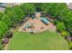 Aerial view of a vibrant community playground with modern play equipment, seating and open green space surrounded by mature trees at 183 Cleveland # B, Atlanta, GA 30316