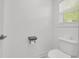 White toilet in a bright bathroom with white walls, next to a window with blinds at 183 Cleveland # B, Atlanta, GA 30316