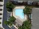 Community swimming pool with lounge chairs and trees, aerial perspective at 2567 Willow Field Se Xing # 22, Marietta, GA 30067