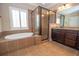 Primary bathroom features soaking tub, shower with glass enclosure, and granite countertops at 2567 Willow Field Se Xing # 22, Marietta, GA 30067