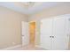 A bedroom featuring a tray ceiling, double doors, and neutral carpet at 2567 Willow Field Se Xing # 22, Marietta, GA 30067