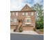 Elegant multi-story townhome featuring a brick facade, bay window, and a convenient attached garage at 2567 Willow Field Se Xing # 22, Marietta, GA 30067