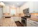 Updated kitchen featuring granite countertops, stainless steel appliances, and ample cabinet space at 2567 Willow Field Se Xing # 22, Marietta, GA 30067