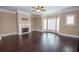 Spacious living room featuring a fireplace, dark hardwood floors, crown molding, and bright windows at 2567 Willow Field Se Xing # 22, Marietta, GA 30067