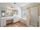 Bathroom featuring white counters, sinks, tile, and gold accents at 2956 Nestle Creek Dr, Marietta, GA 30062