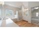 Bright bathroom featuring a double sink, soaking tub, glass enclosed shower, and walk-in closet at 2956 Nestle Creek Dr, Marietta, GA 30062