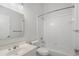 The all-white bathroom features a shower and tub, toilet and sink with countertop space, reflecting cleanliness and brightness at 2956 Nestle Creek Dr, Marietta, GA 30062