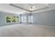 Spacious bedroom with trey ceilings, fan, carpet floors, and plenty of natural light from windows at 2956 Nestle Creek Dr, Marietta, GA 30062