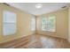 Bright bedroom featuring three windows offering natural light and light-colored wooden floors at 2956 Nestle Creek Dr, Marietta, GA 30062