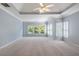 Spacious bedroom with trey ceilings, fan, carpet floors, and plenty of natural light from windows at 2956 Nestle Creek Dr, Marietta, GA 30062