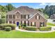 Charming brick home with manicured lawn, mature landscaping, and a welcoming blue front door at 2956 Nestle Creek Dr, Marietta, GA 30062