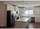 Modern kitchen featuring white cabinets, stainless steel appliances, and a large center island at 5099 Noble Village Way, Lilburn, GA 30047