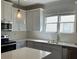 Modern kitchen featuring white cabinets, stainless steel appliances, and a bright window at 5099 Noble Village Way, Lilburn, GA 30047
