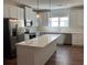 Modern kitchen featuring white cabinets, stainless steel appliances, and a large center island at 5099 Noble Village Way, Lilburn, GA 30047