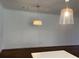 Bright living room featuring hardwood floors, modern lighting fixtures, and neutral wall paint at 5099 Noble Village Way, Lilburn, GA 30047