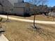 Nice landscaped yard with a sidewalk leading away at 5099 Noble Village Way, Lilburn, GA 30047