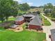 Aerial view of brick home with multiple decks and fire pit, nestled on a sprawling lot at 2631 Young Rd, Stone Mountain, GA 30088