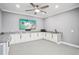 Stylish bar area with white cabinetry, granite countertops, microwave, and flatscreen TV for entertainment at 2631 Young Rd, Stone Mountain, GA 30088