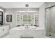 Luxurious bathroom features a soaking tub, glass block window, and tiled shower at 2631 Young Rd, Stone Mountain, GA 30088