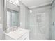 Modern bathroom featuring glass enclosed shower, marble tile, and quartz countertop sink vanity at 2631 Young Rd, Stone Mountain, GA 30088