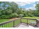 A backyard deck showcasing a serene green lawn and lush trees for relaxation and privacy at 2631 Young Rd, Stone Mountain, GA 30088