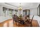 Formal dining room featuring hardwood floors, elegant chandelier, and large windows with custom valances at 2631 Young Rd, Stone Mountain, GA 30088