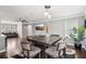 Cozy dining room featuring modern chandelier, flatscreen TV, and nearby living room seating at 2631 Young Rd, Stone Mountain, GA 30088