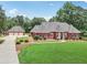 Beautiful brick home features a well-manicured lawn, lush landscaping, and a detached three-car garage at 2631 Young Rd, Stone Mountain, GA 30088